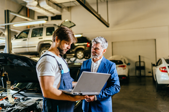 Business man and technician talking in workshop