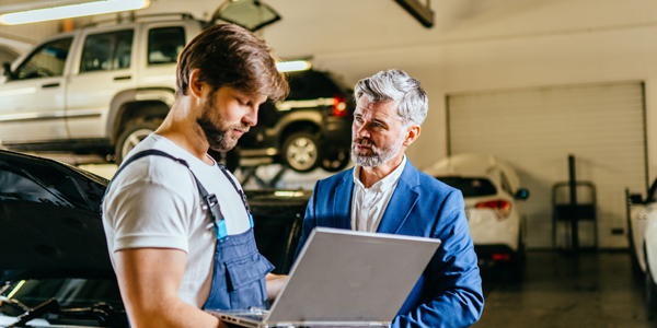 Business man and technician talking in workshop